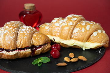 close up photo of croissant with cherries and ingredients