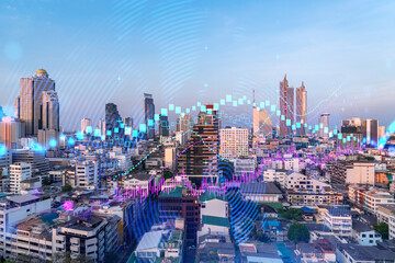 Glowing FOREX graph hologram, aerial panoramic cityscape of Bangkok at sunset. Stock and bond trading in Asia. The concept of fund management. Double exposure.