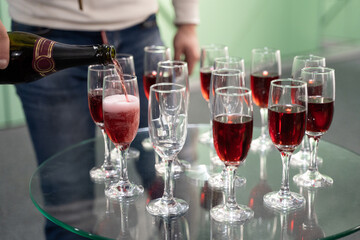 bartender pours champagne into a glass