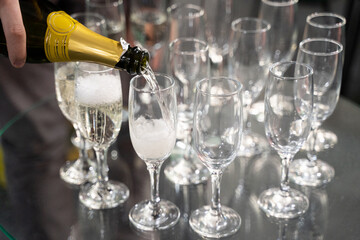 bartender pours champagne into a glass