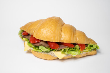 close up photo of a croissant with stuffing on a white background