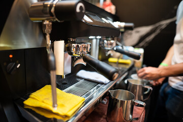 Fototapeta na wymiar A barista in a coffee machine makes coffee