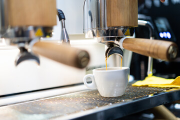 A barista in a coffee machine makes coffee