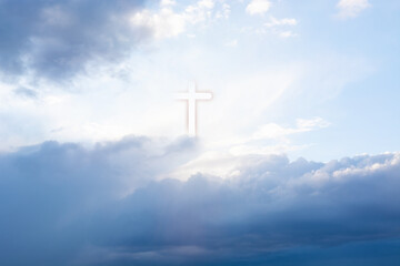 Christian cross appears bright in cloudy dark sky background