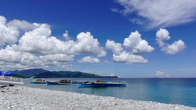 Beautiful Looc Beach With Boats Moored On The Calm Ocean And Clouds Rolling Above In Surigao Del Norte, Philippines. -Timelapse