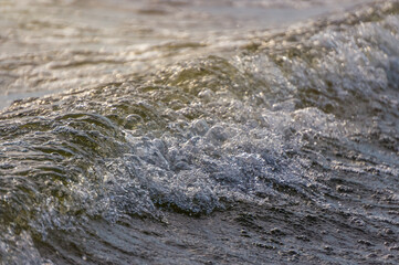 Wave and sparkling sunny surface of the water