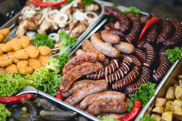delicious grilled sausages with salad and vegetables