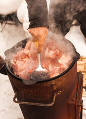Cooking pilaf of lamb in a pot on the stove