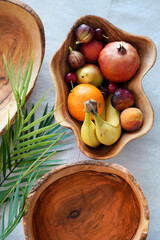 Wooden handmade bowls with fruits on the table. Top vew. Say no to plastic. Eco concept
