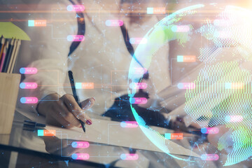 Multi exposure of hands making notes with world map hologram and data theme icons. Concept of global data.