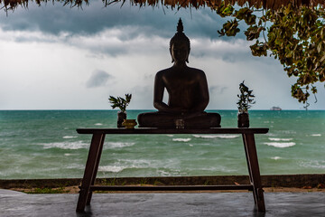 silhouette of the lord buddha against the backdrop of thunderclouds on samui island in thailand,...