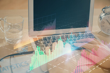 Multi exposure of market chart with man working on computer on background. Concept of financial analysis.