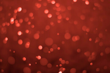Red glitter vintage lights background. Red bokeh on black background.
