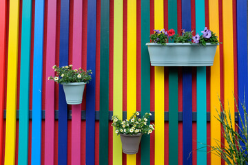 colourful garden fence with flower baskets