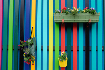colourful fence with flower baskets