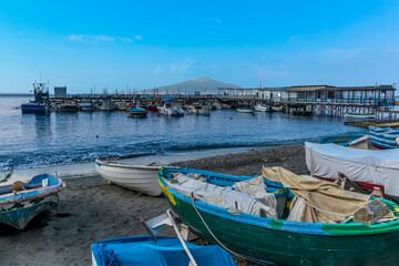 Fototapeta na wymiar A view from the beach in Marina Grande, Sorrento, Italy towards the Bay of Naples and Mount Vesuvius