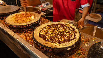 Varieties of dosa cooked in a counter at a food festival