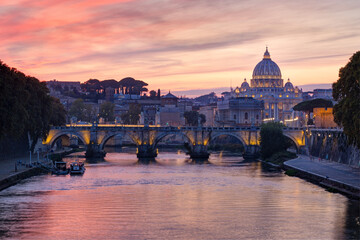 View from the Tiber on Ponte Sant'Angelo and St. Peter's Basilica in the twilight,  Rome, Italy.