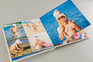 open photo book on a gray background