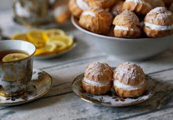 Profiterols and tea on the table. Food concept. Homemade sweet
