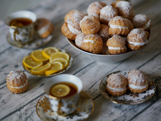 Profiterols and tea on the table. Food concept. Homemade sweet