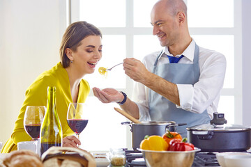 Smiling young couple cooking food in the kitchen