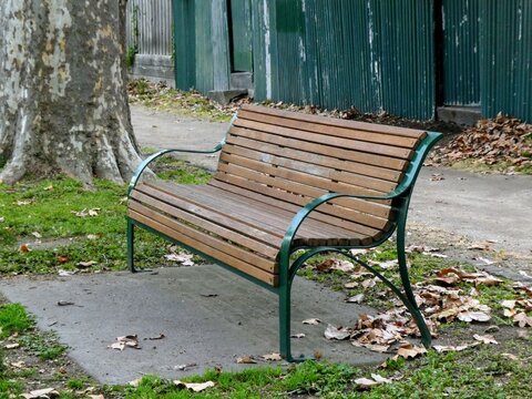 Wood and metal public park bench in an urban setting
