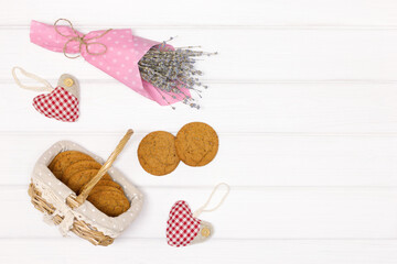 Fototapeta na wymiar Fresh baked cookies on white wood table with rural decor. Flat lay composition. Rustic background. Copy space