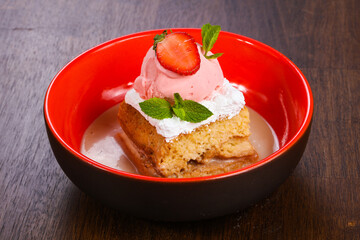 Cake with ice cream served stravberry