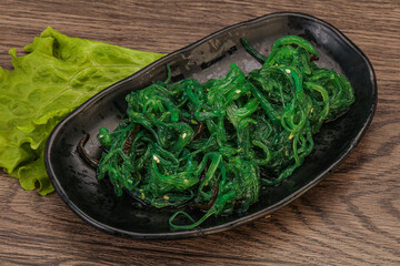 Green Chuka Seaweed Salad Isolated on White Background Top View. Wakame Sea Kelp Salat