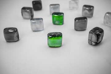 two green glass stones between black and white