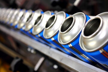 blue aerosol cans on production line