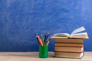 Education concept - books on the desk in the auditorium