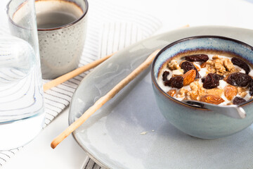 Greek type yoghurt with almons, walnuts, raisins and honey. Healthy vegetarian breakfast.