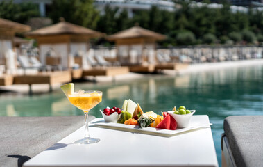 Fruit plate cocktail glasses, on the beach summer vacation. Travel and sea concept.