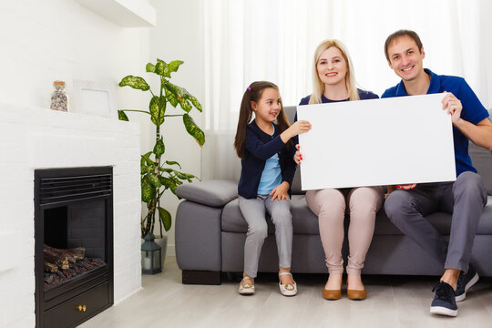 family holds holds photo canvas at home