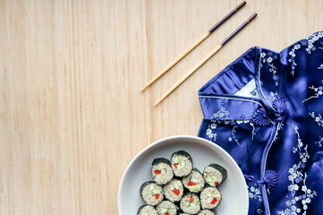 Vegan sushi with chopsticks. Sushi from kinoa with bellpeper, avocado, cucumber