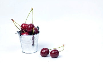 bucket of black cherry isolated on white background