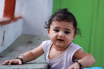 Fototapeta premium Cute Indian Kid Giving Pose To Camera With Beautiful Smile.