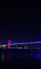 Bosphorus bridge at night in Istanbul, navy blue sky and sea