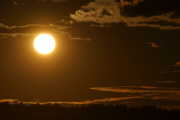 Sunset with curled clouds. the color of the sky is orange. Close up.