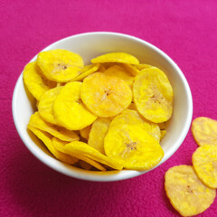 Banana chips kept in bowl beautifully placed in pink background