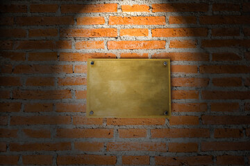 Blank Brass sign on brick wall texture with light