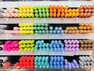 Colorful pens arranged on shelves selling stationery. Office supplies and stationery