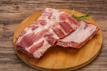 Raw pork ribs served rosemary