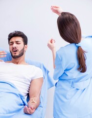 Woman doctor examining male patient in hospital