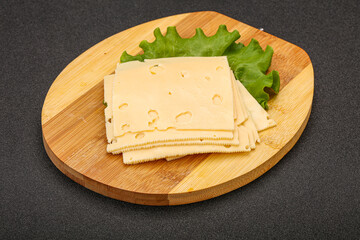 Sliced yellow cheese over board