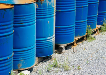 Big oil drums, blue. Chemical barrels in an open warehouse. Rusty barrels. Barrel for oil