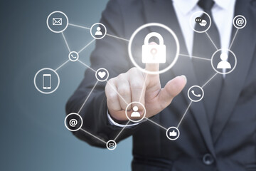 Businessman hand pressing lock icon on virtual screen for social network connection. Concept of personal data security.