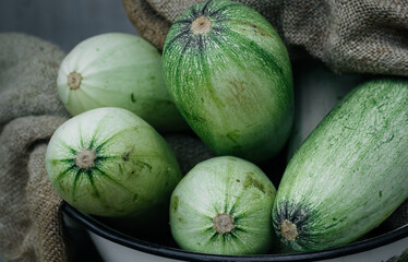 Vegetable marrow. Pumpkin. Fresh vegetables in a bowl.  Low-calorie food.